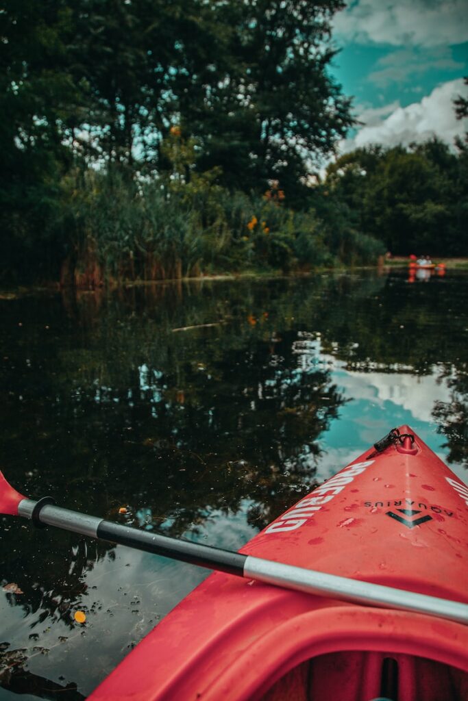 red kayak on lake during daytime